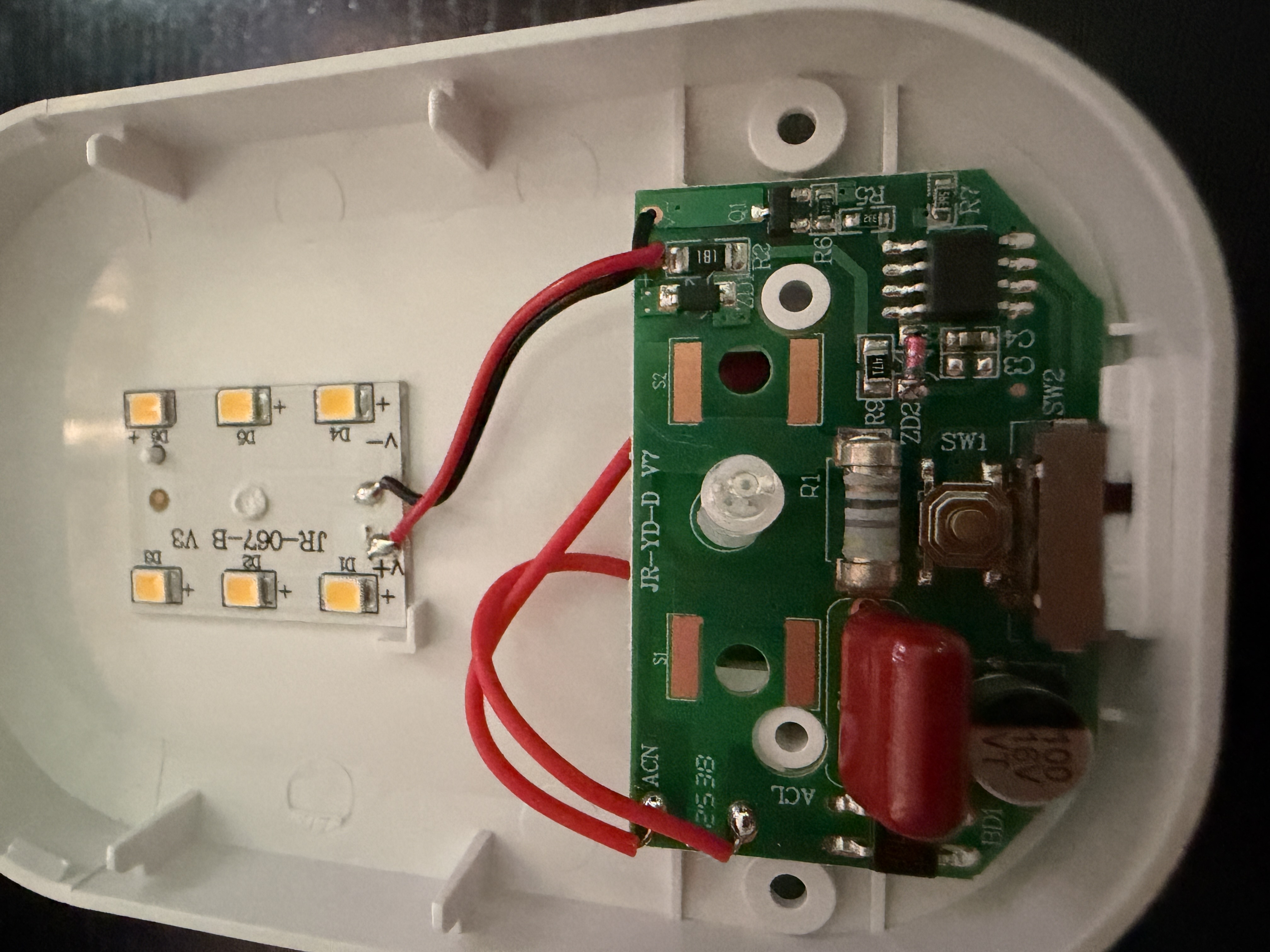 The night light opened up, showing the LED board and the driver board